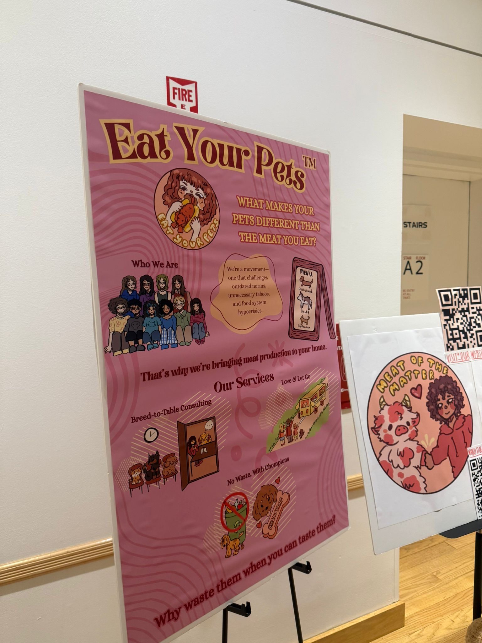 The Eat Your Pets poster on an easel at the exhibition
