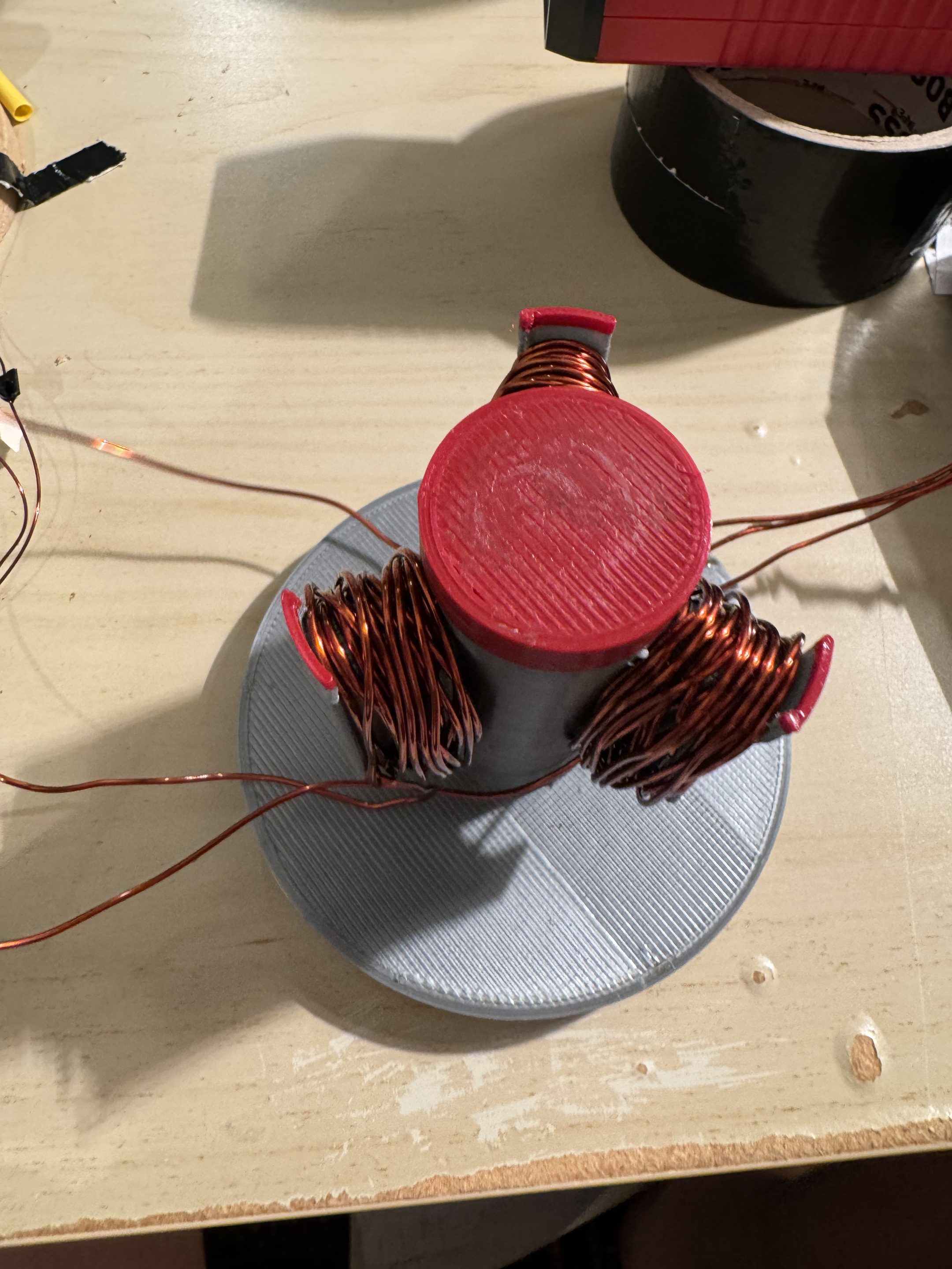 Early stator prototype in red and grey PLA with loose windings