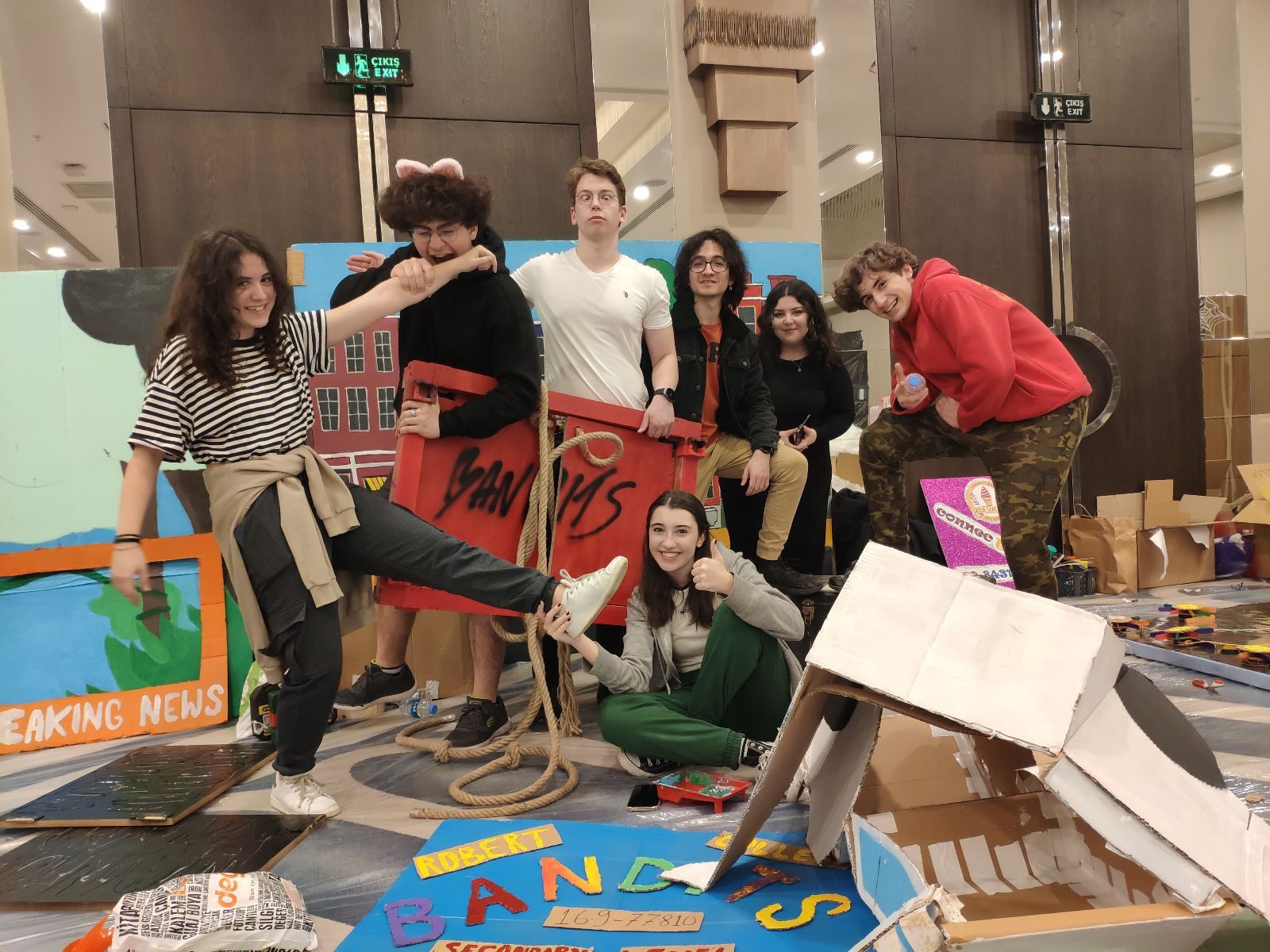 The team with the painted flats and cardboard set pieces they built