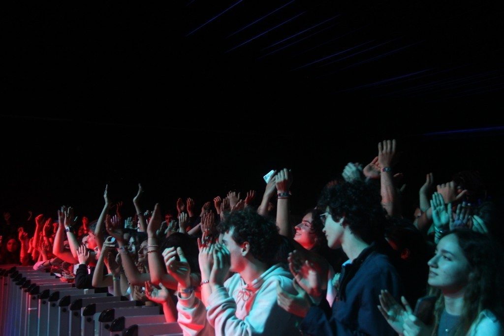 Crowd with raised hands at a night concert