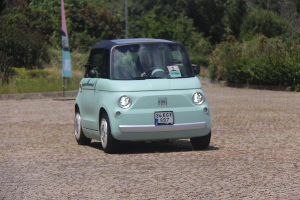 Mint green Fiat Topolino parked on a cobbled forecourt
