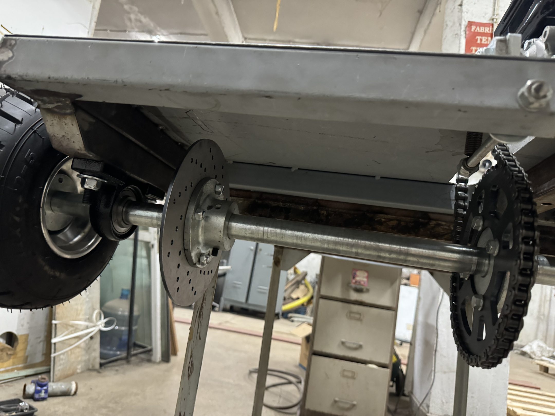 Rear axle with brake disc and sprocket seen from below