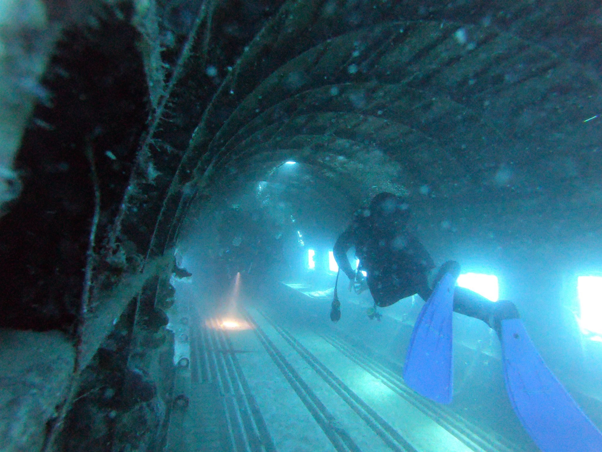 Diver inside the fuselage of a sunken aircraft